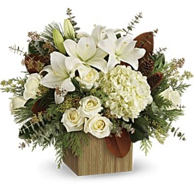 Give the gift of modern winter-white style with this breathtaking bouquet, hand-arranged in a wooden cube.

This winter bouquet includes white hydrangea, white roses, white asiatic lilies, magnolia leaves, seeded eucalyptus, spiral eucalyptus, flat cedar and white pine.